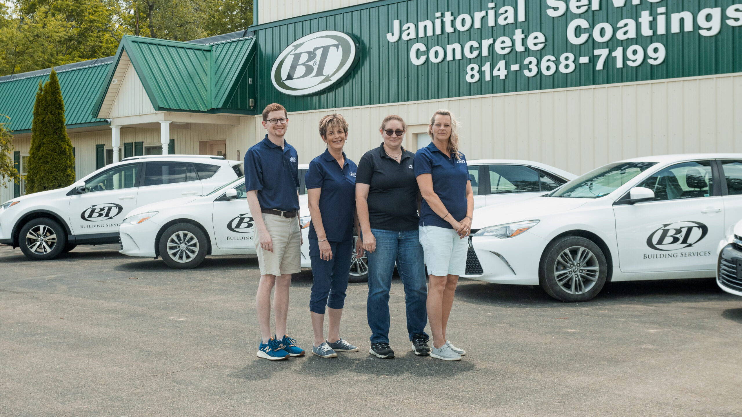 team members standing in front of B&T facility in company shirts